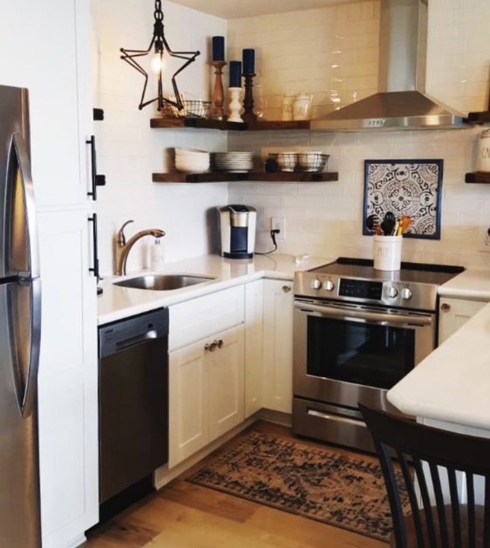 A kitchen with a small patterned rug on the floor